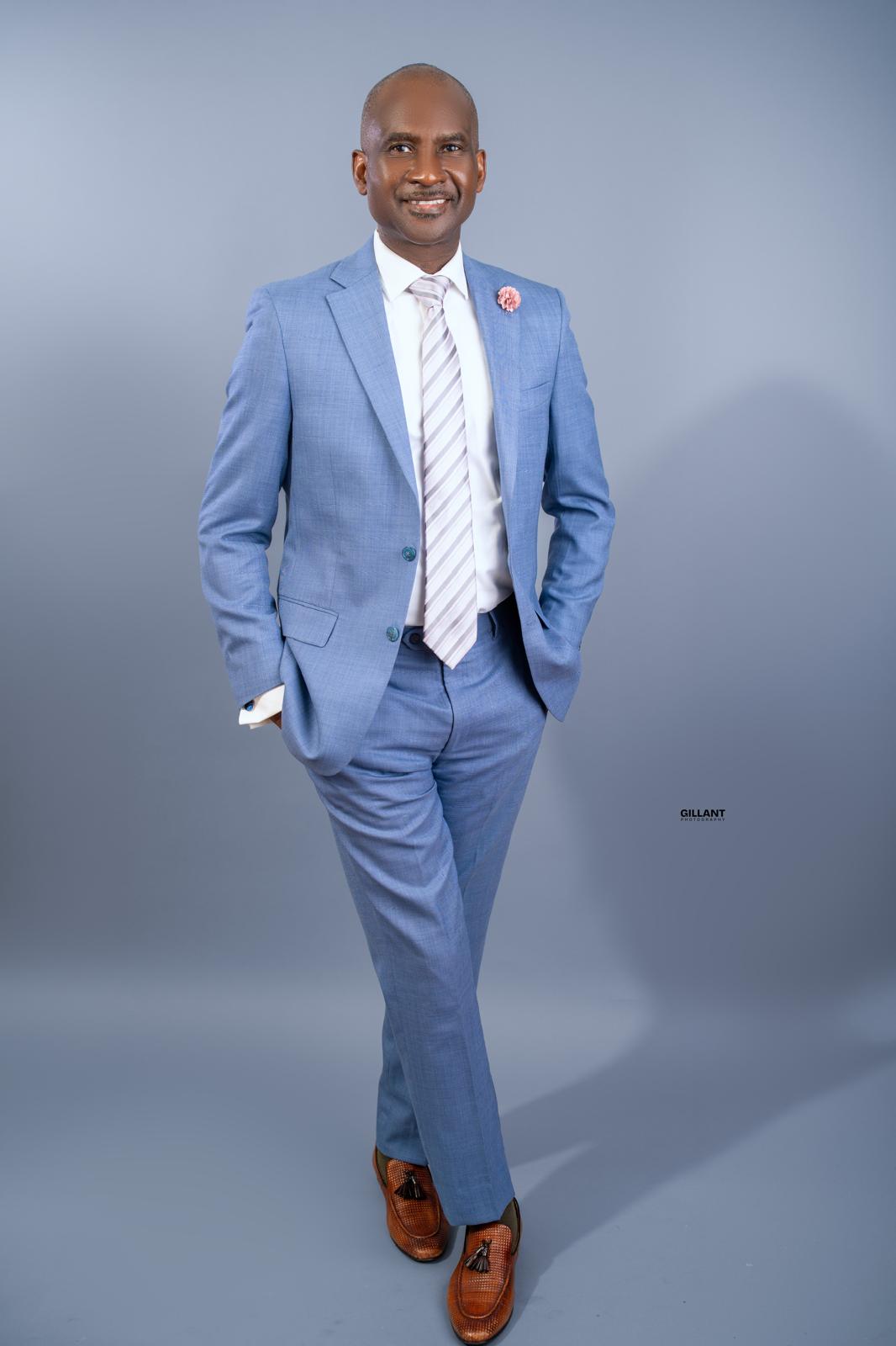 Mutiu Babatunde standing confidently in a blue suit
