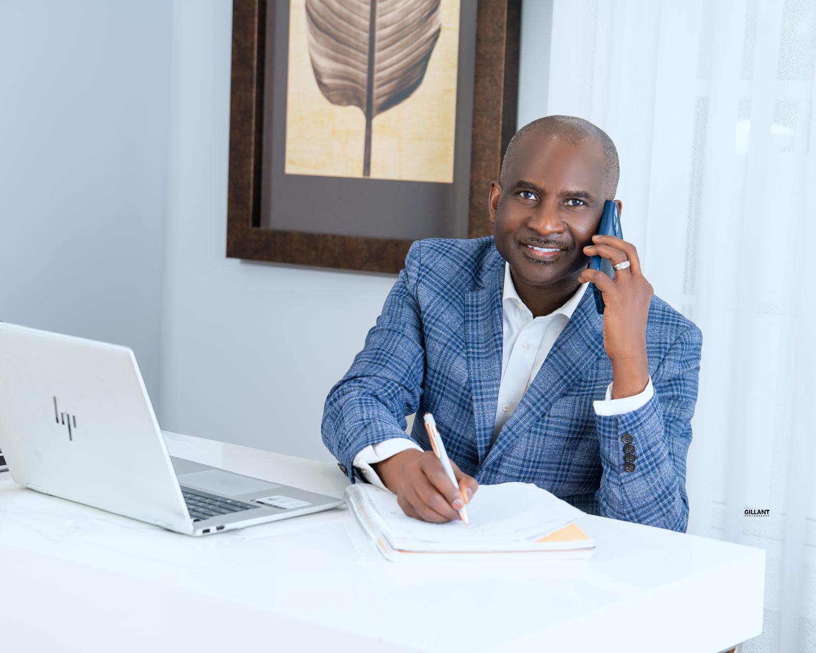 Mutiu Babatunde speaking on the phone at his desk