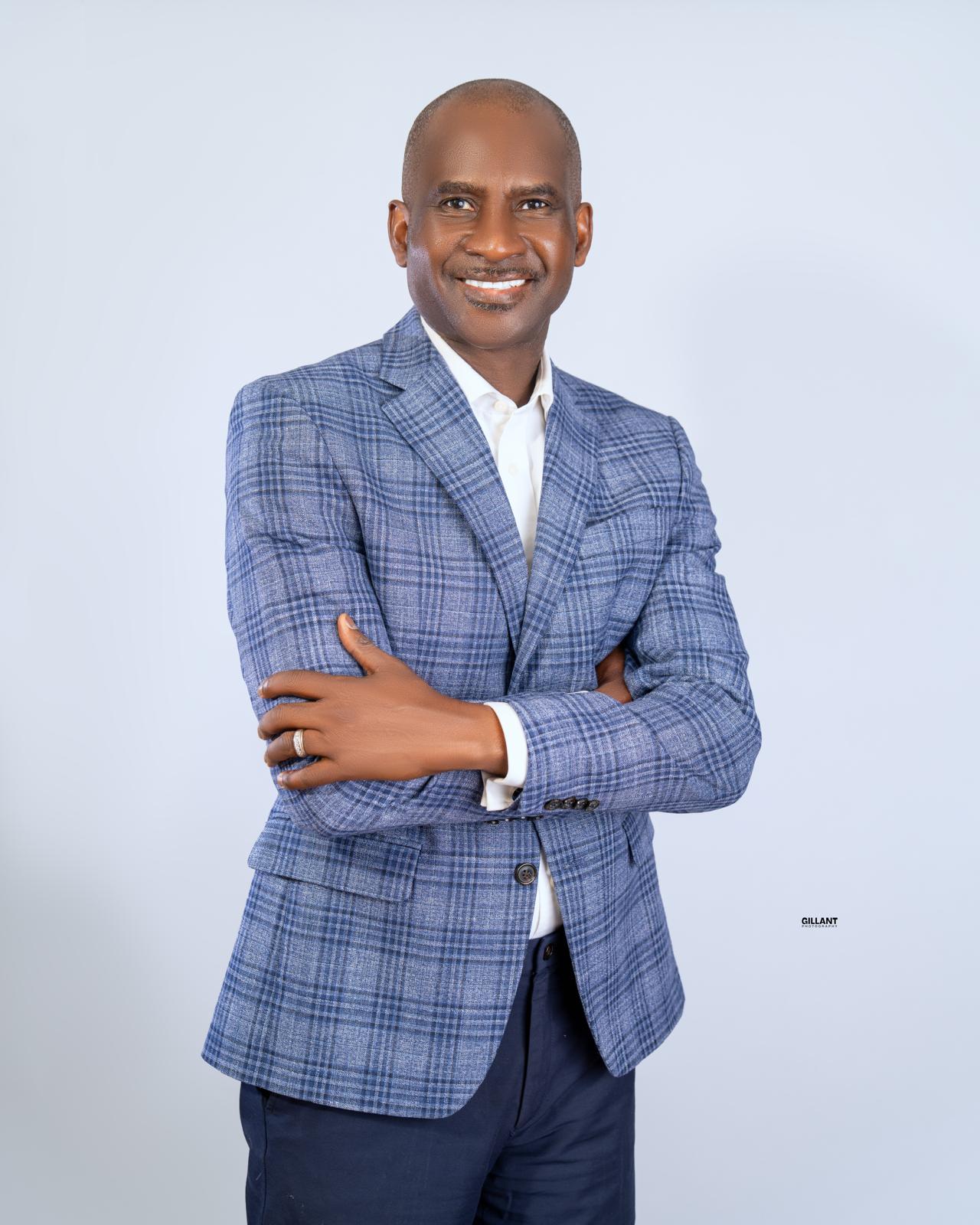 Mutiu Babatunde smiling in a blue checked jacket